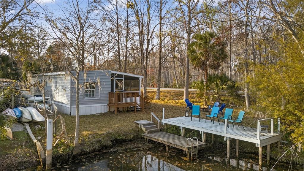 7286 Aberdeen Court Weeki Wachee, FL 34607 - Photo 21 of 37 a view of house with a backyard and sitting area