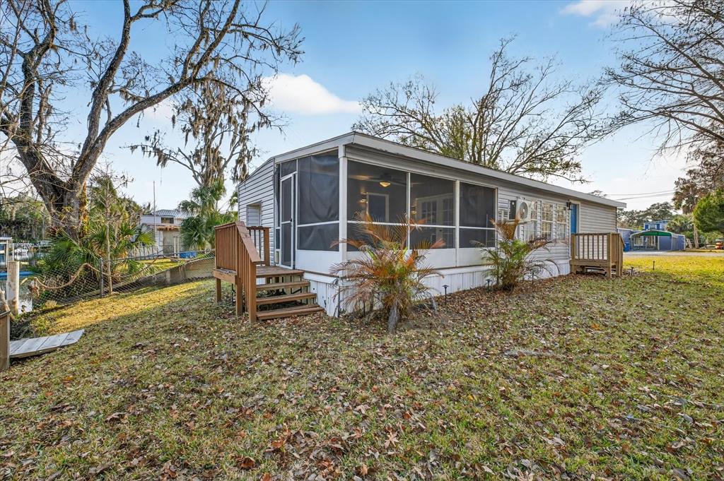 7286 Aberdeen Court Weeki Wachee, FL 34607 - Photo 23 of 37 a backyard of a house with table and chairs