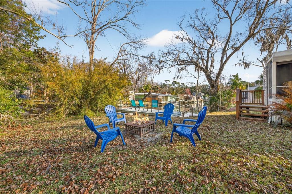 7286 Aberdeen Court Weeki Wachee, FL 34607 - Photo 26 of 37 a backyard of a house with table and chairs