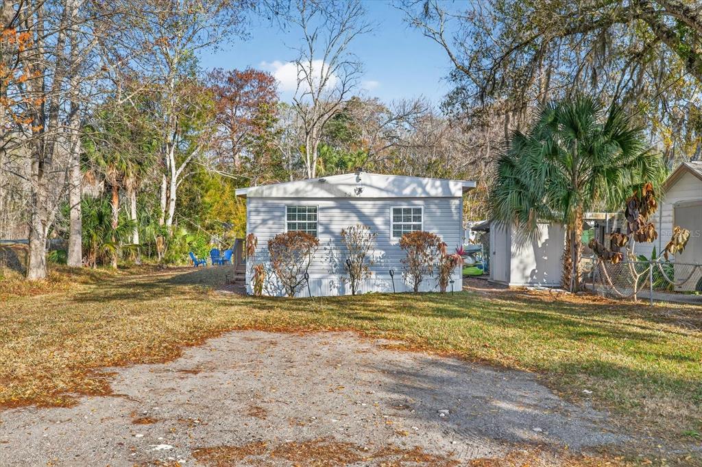 7286 Aberdeen Court Weeki Wachee, FL 34607 - Photo 30 of 37 a view of a house with a yard and tree s