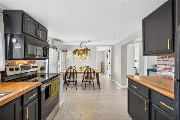 a large kitchen with stainless steel appliances granite countertop a stove and a sink