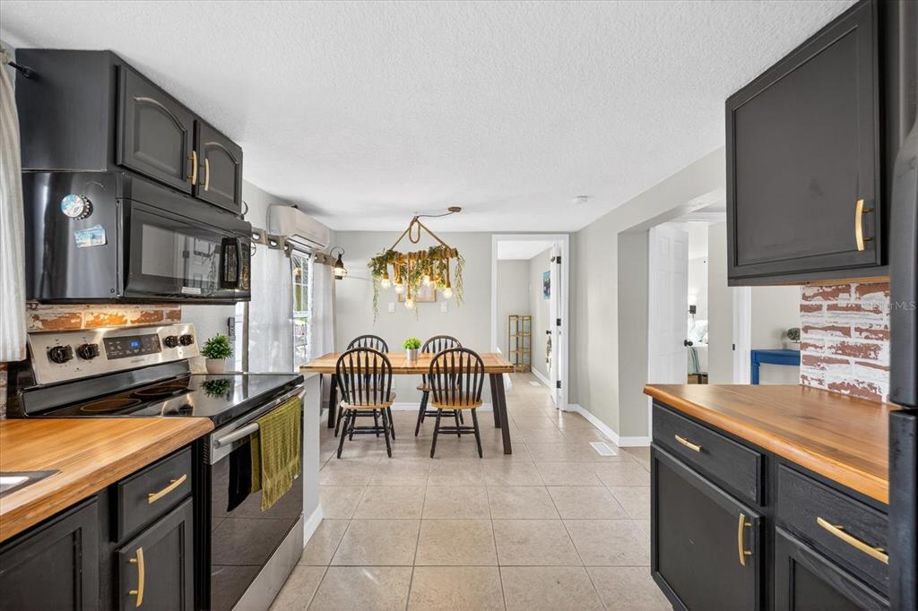 7286 Aberdeen Court Weeki Wachee, FL 34607 - Photo 3 of 37 a large kitchen with stainless steel appliances granite countertop a stove and a sink