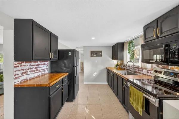 a kitchen with stainless steel appliances granite countertop a stove and a refrigerator