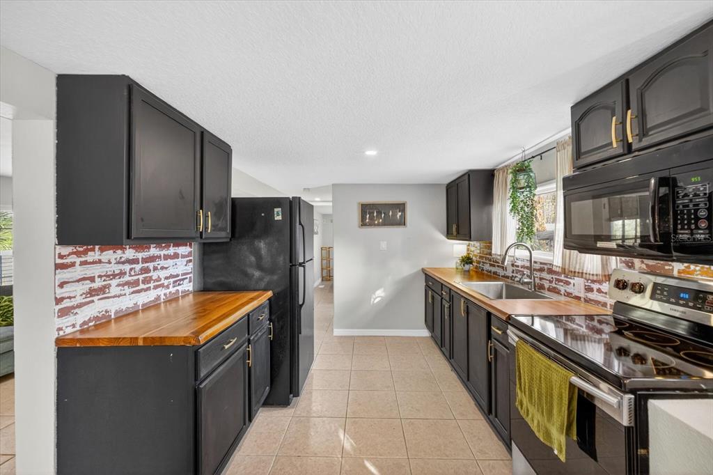 7286 Aberdeen Court Weeki Wachee, FL 34607 - Photo 5 of 37 a kitchen with stainless steel appliances granite countertop a stove and a refrigerator