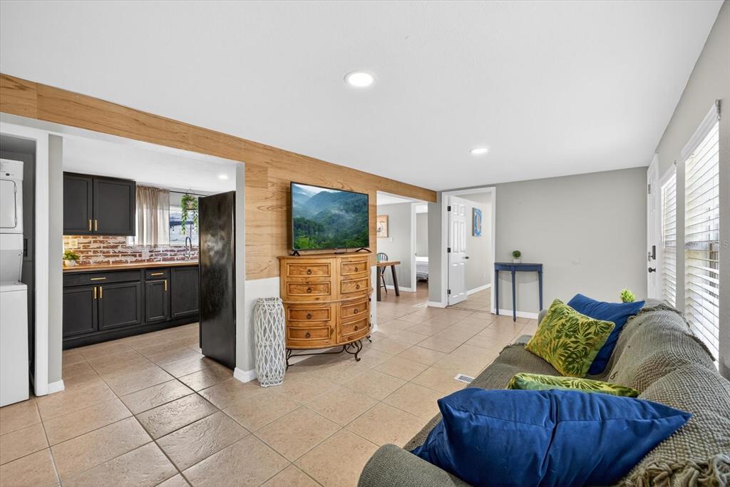 7286 Aberdeen Court Weeki Wachee, FL 34607 - Photo 9 of 37 a living room with furniture and a flat screen tv