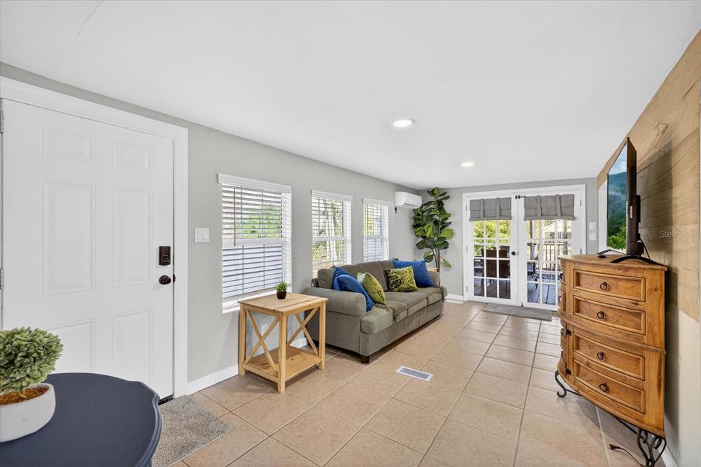 7286 Aberdeen Court Weeki Wachee, FL 34607 - Photo 10 of 37 a living room with furniture and a flat screen tv