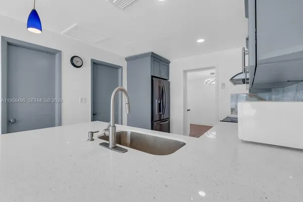a bathroom with a tub sink and mirror