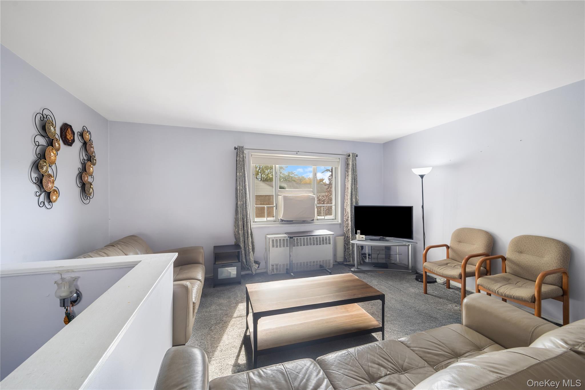 225-08 88th Avenue, Unit UPPR Queens, NY 11435 - Photo 11 of 20 a living room with furniture and a flat screen tv