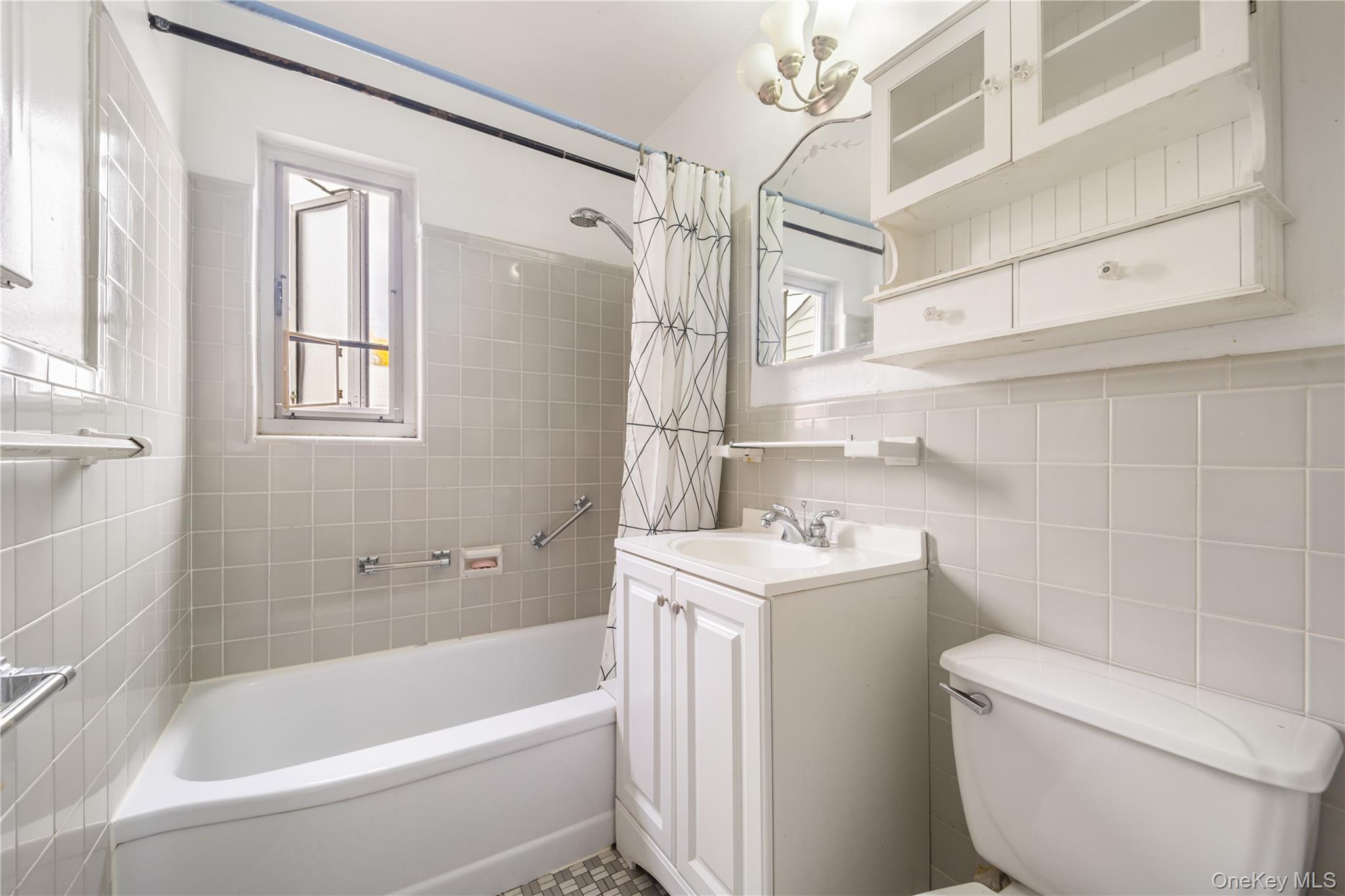 225-08 88th Avenue, Unit UPPR Queens, NY 11435 - Photo 13 of 20 a bathroom with a sink a toilet and shower