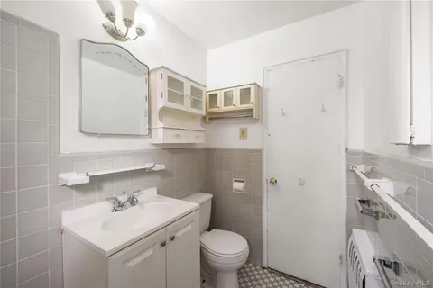a bathroom with a sink toilet and mirror