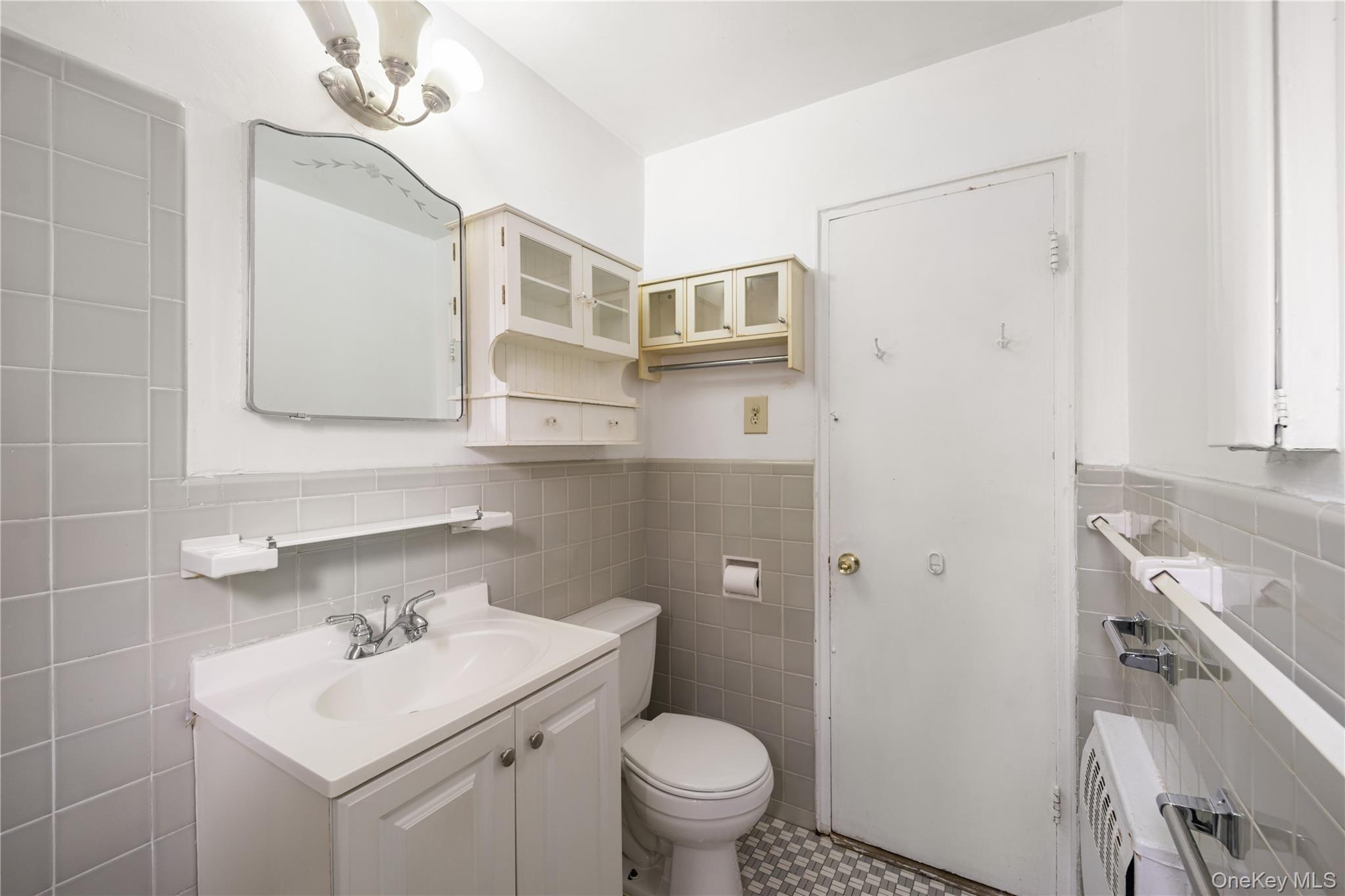 225-08 88th Avenue, Unit UPPR Queens, NY 11435 - Photo 14 of 20 a bathroom with a sink toilet and mirror