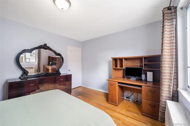 a bedroom with a bed and a desk