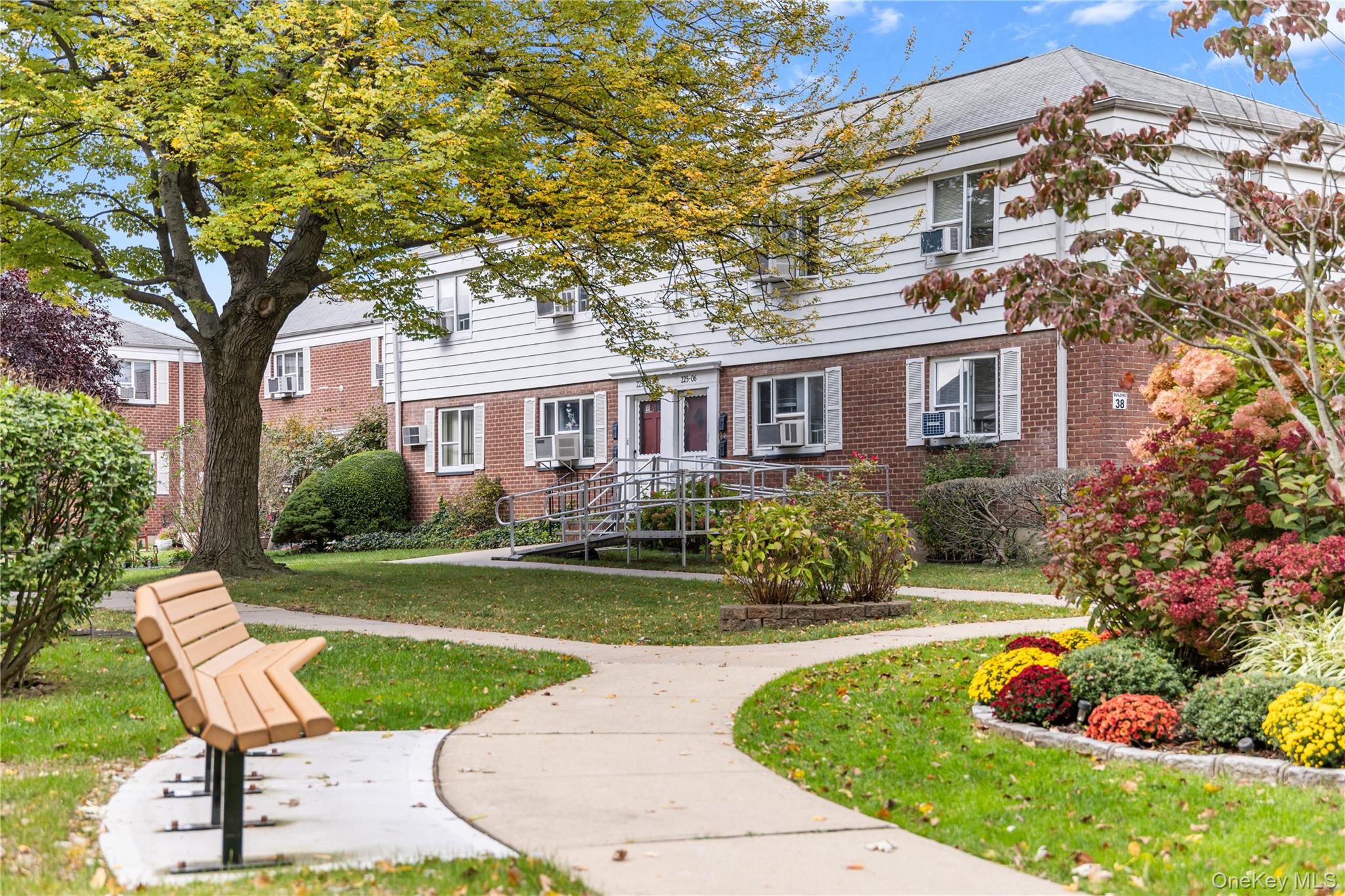 225-08 88th Avenue, Unit UPPR Queens, NY 11435 - Photo 2 of 20 front view of a house with a yard