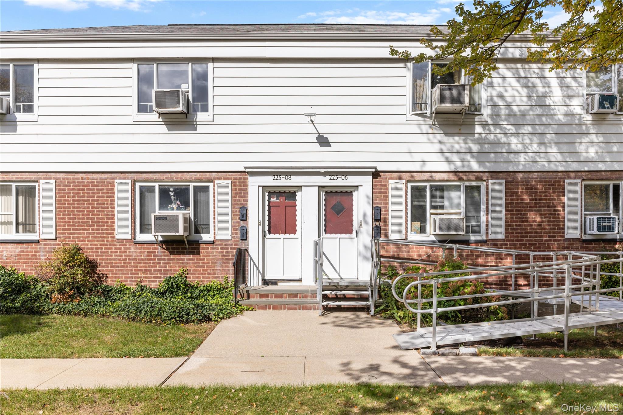 225-08 88th Avenue, Unit UPPR Queens, NY 11435 - Photo 3 of 20 front view of a house with a bench