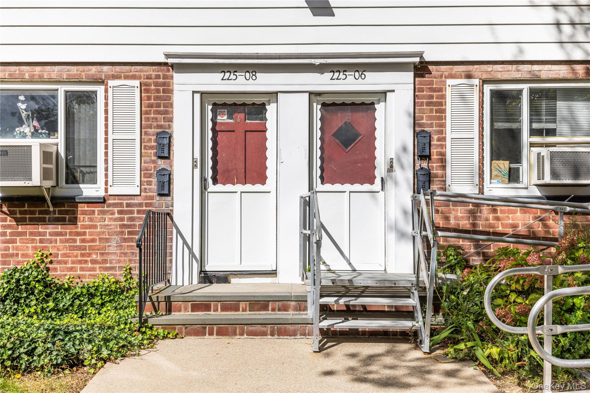 225-08 88th Avenue, Unit UPPR Queens, NY 11435 - Photo 4 of 20 a front view of a house with a garden