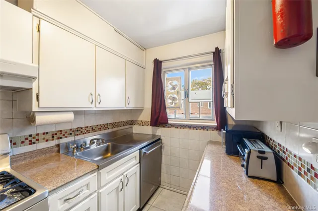 a kitchen that has a sink and a stove