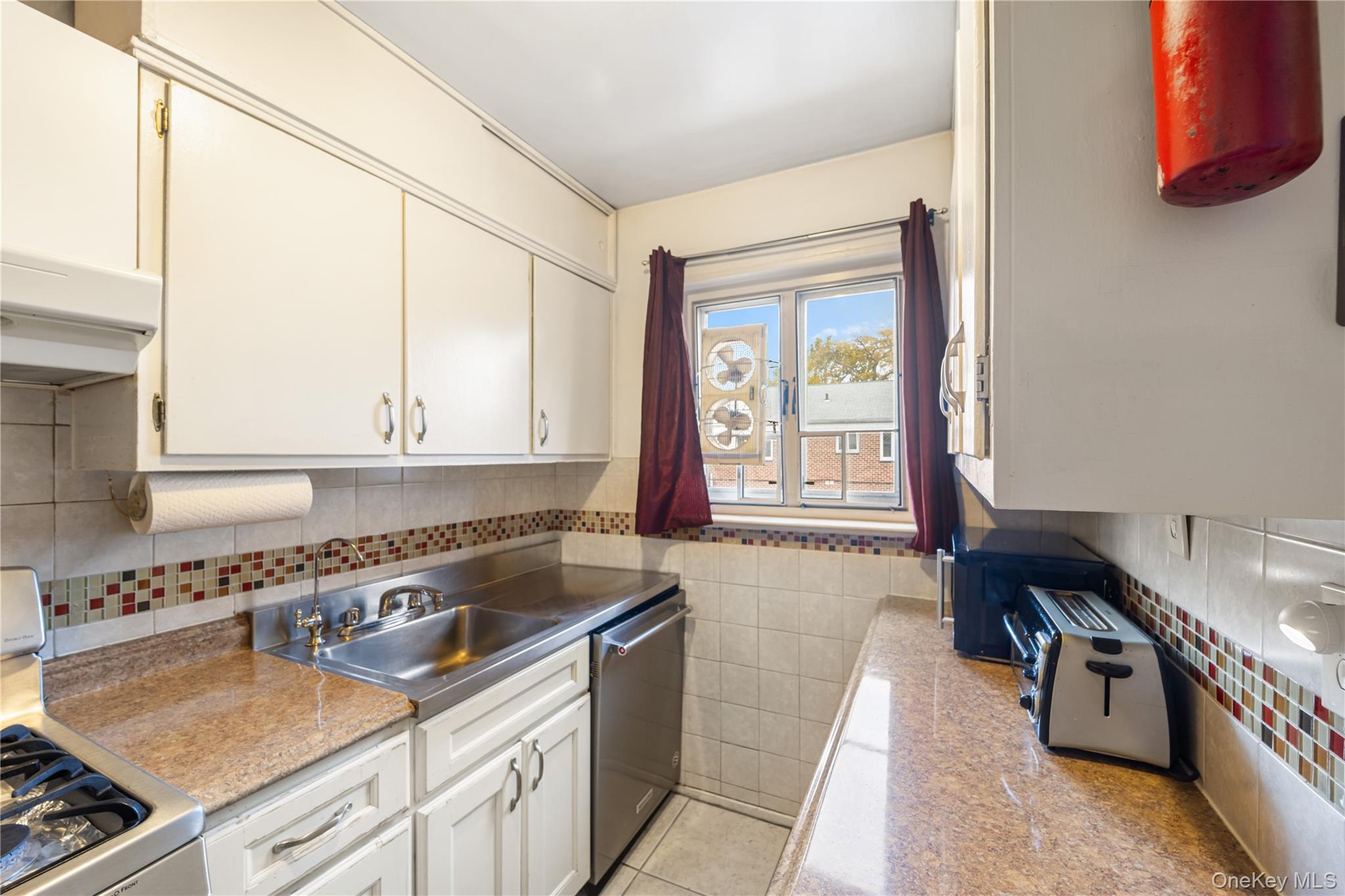 225-08 88th Avenue, Unit UPPR Queens, NY 11435 - Photo 7 of 20 a kitchen that has a sink and a stove