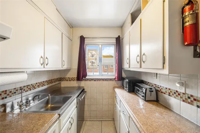 a kitchen with stainless steel appliances granite countertop a sink and a stove