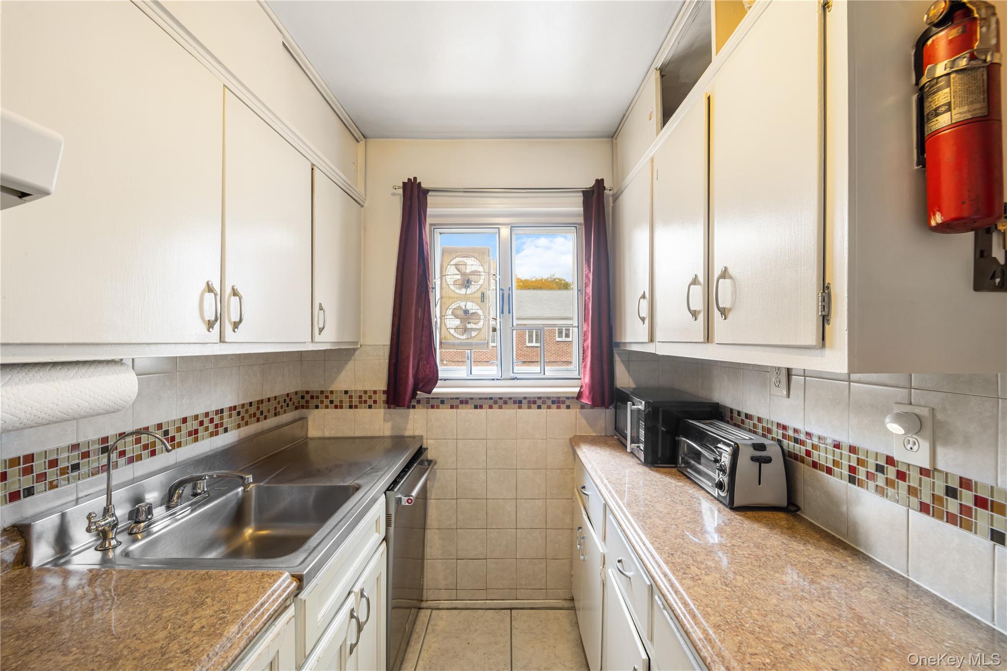 225-08 88th Avenue, Unit UPPR Queens, NY 11435 - Photo 9 of 20 a kitchen with stainless steel appliances granite countertop a sink and a stove
