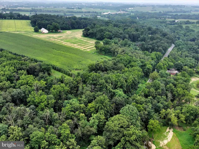 an aerial view of a houses with a yard