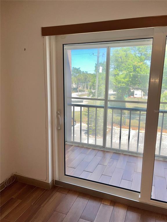 519 Albee Farm Road, Unit 303 Venice, FL 34285 - Photo 11 of 58 a view of an empty room with wooden floor and a window