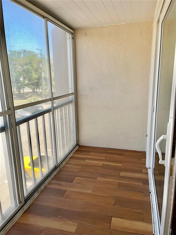 519 Albee Farm Road, Unit 303 Venice, FL 34285 - Photo 14 of 58 a view of a room with wooden floor and windows