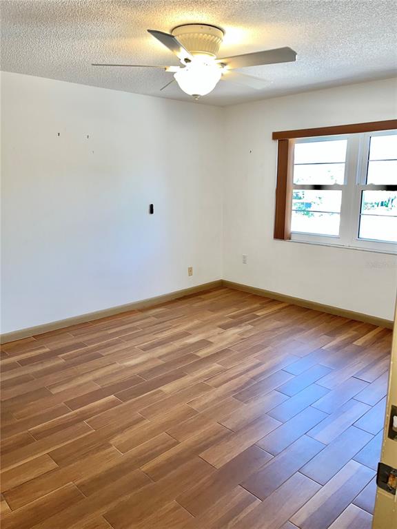 519 Albee Farm Road, Unit 303 Venice, FL 34285 - Photo 18 of 58 a view of a room with wooden floor and fan
