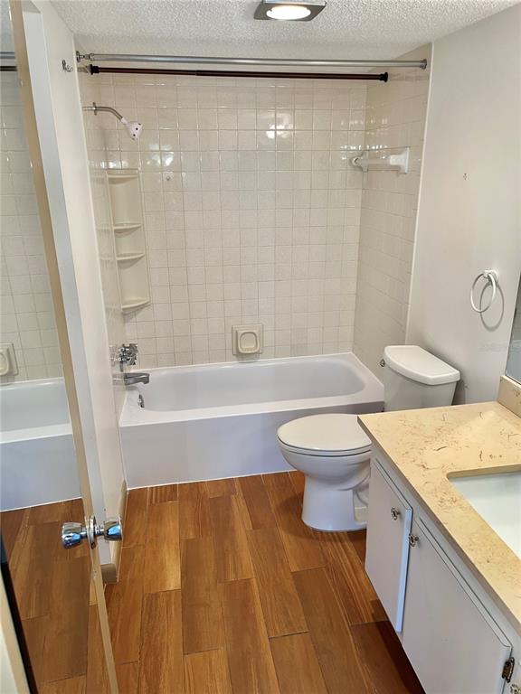 519 Albee Farm Road, Unit 303 Venice, FL 34285 - Photo 21 of 58 a bathroom with a granite countertop bathtub shower sink vanity and toilet