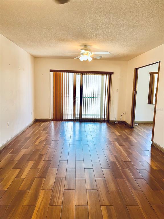 519 Albee Farm Road, Unit 303 Venice, FL 34285 - Photo 8 of 58 wooden floor in an empty room with a window