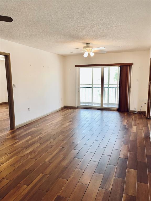 519 Albee Farm Road, Unit 303 Venice, FL 34285 - Photo 10 of 58 a view of an empty room with wooden floor and a window