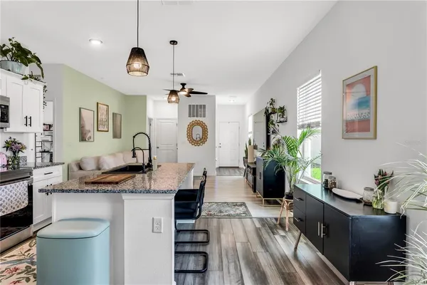 a large kitchen with a table and chairs