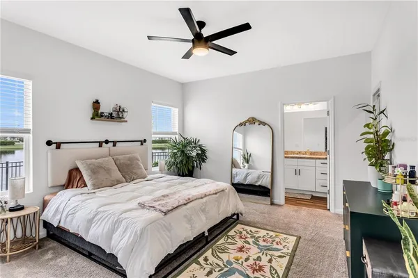 a bedroom with a bed a dresser and chair