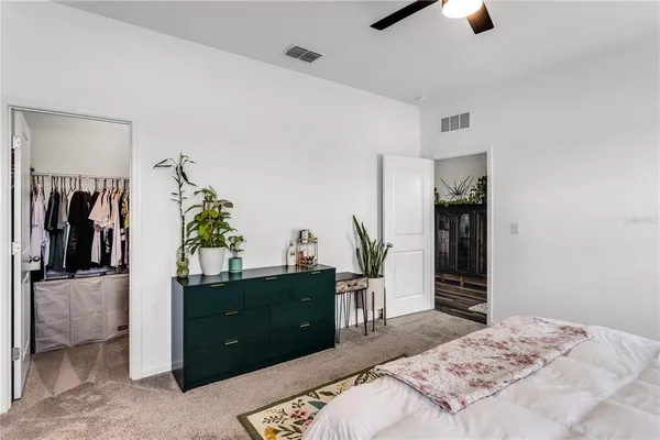 a bedroom with a bed and a television