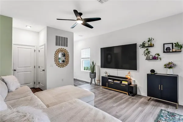 a bedroom with furniture and a flat screen tv