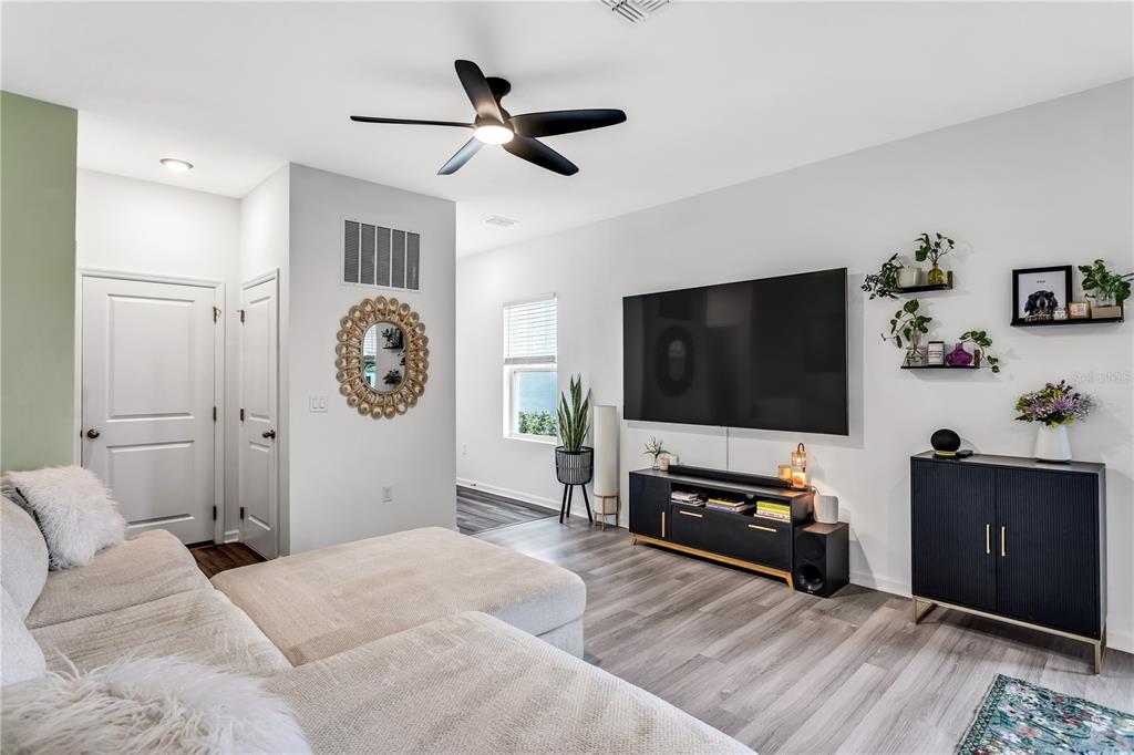 10459 Ladybug Cove Parrish, FL 34219 - Photo 2 of 36 a bedroom with furniture and a flat screen tv