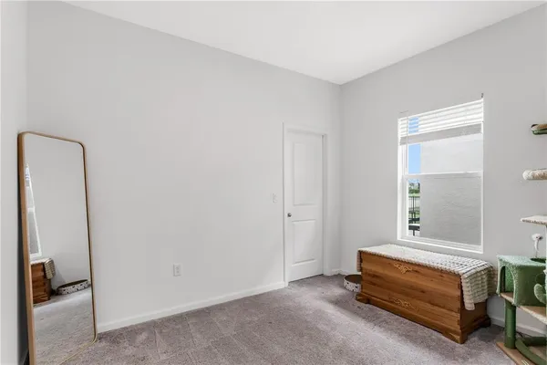 a spacious bedroom with a bed and a window