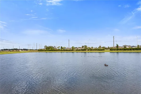 a view of a lake with boats and trees in the background