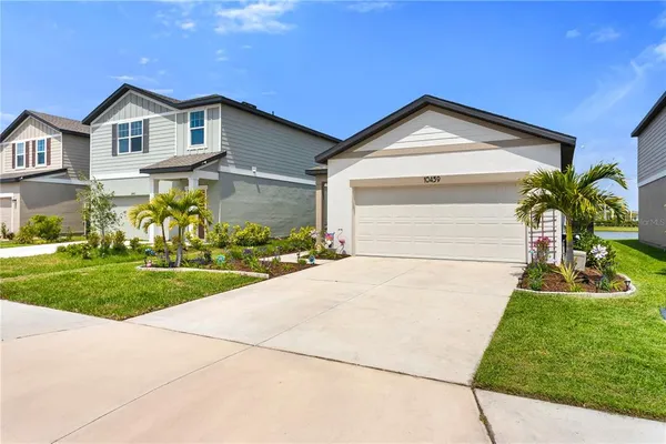 a front view of a house with a yard and garage