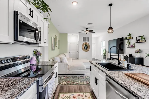 a kitchen with stove and cabinets