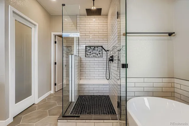 a bathroom with a bathtub and shower