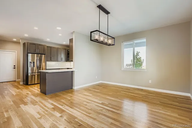 a kitchen with stainless steel appliances kitchen island a sink dishwasher a refrigerator and a stove