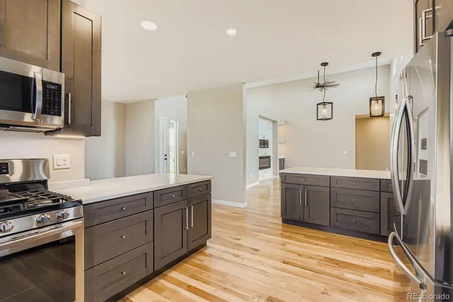 a large kitchen with stainless steel appliances and a refrigerator