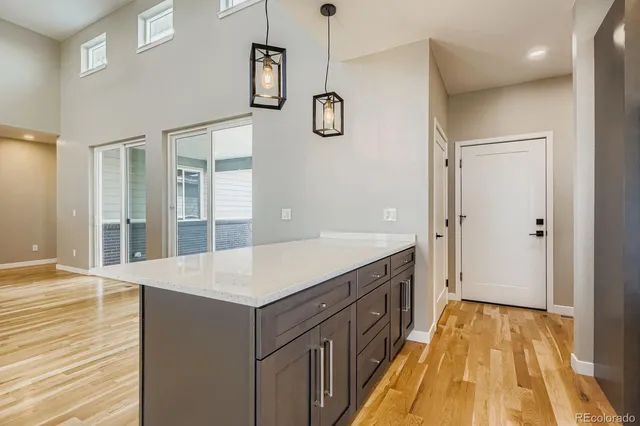 a spacious bathroom with a granite countertop sink a mirror and shower