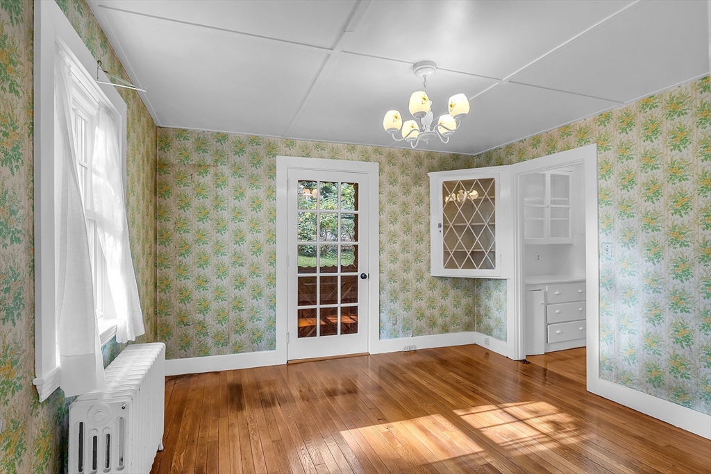 42 Locust Street Marblehead, MA 01945 - Photo 14 of 42 a view of an empty room with a window and wooden floor
