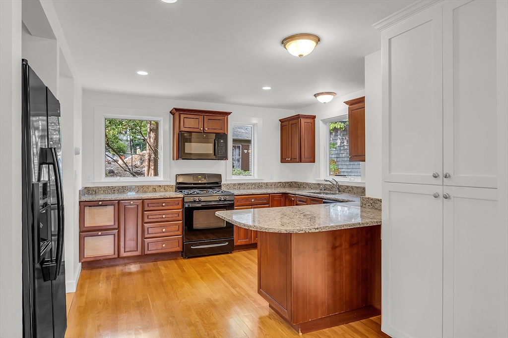 42 Locust Street Marblehead, MA 01945 - Photo 17 of 42 a kitchen with stainless steel appliances granite countertop a sink stove and refrigerator