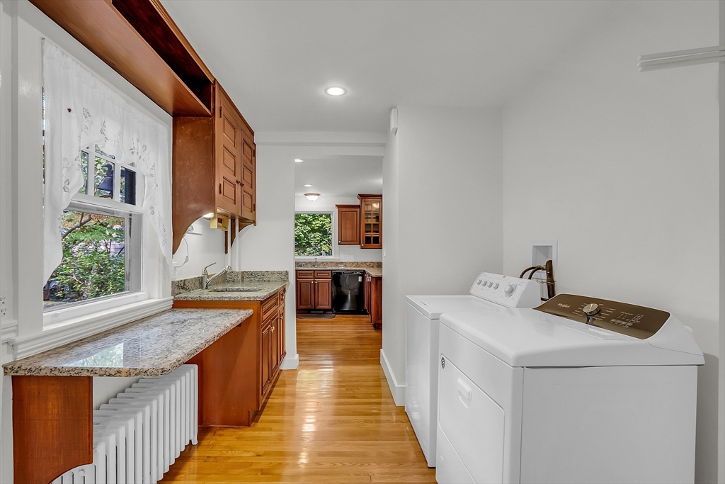 42 Locust Street Marblehead, MA 01945 - Photo 19 of 42 a dining hall with stainless steel appliances granite countertop a sink a stove and a wooden floors