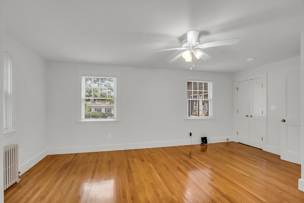 42 Locust Street Marblehead, MA 01945 - Photo 22 of 42 a view of empty room with wooden floor and fan