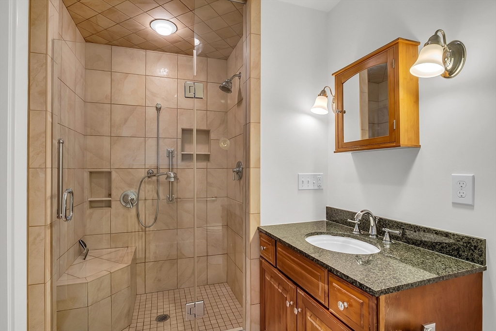 42 Locust Street Marblehead, MA 01945 - Photo 23 of 42 a bathroom with a granite countertop sink a mirror and shower
