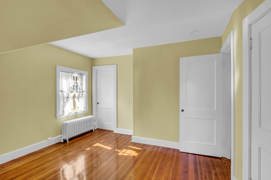 42 Locust Street Marblehead, MA 01945 - Photo 25 of 42 a view of an empty room with wooden floor and a window