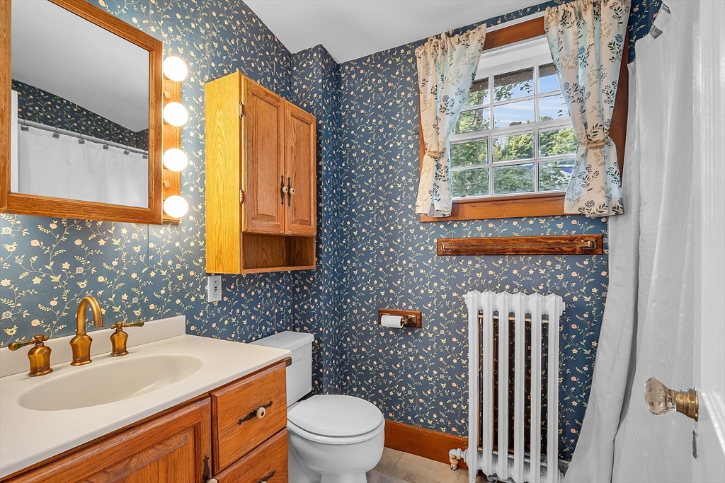 42 Locust Street Marblehead, MA 01945 - Photo 29 of 42 a bathroom with a sink a toilet and a mirror